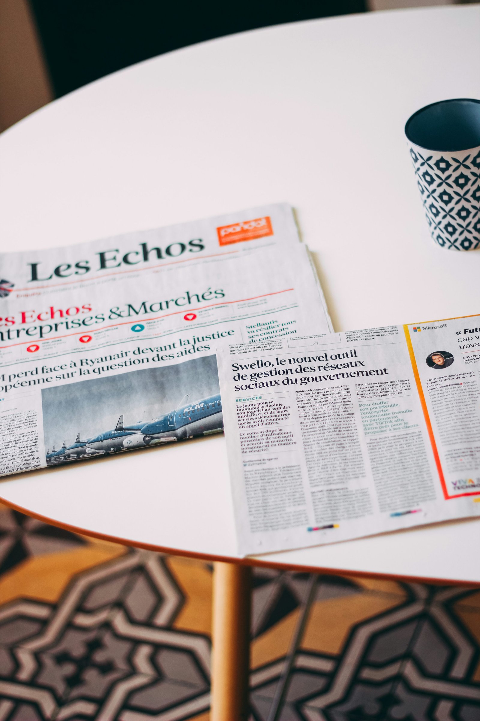 A newspaper placed on a white tabletop, representing informational guidance about sick leave rights for foreign workers in France.